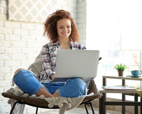 Woman using laptop at home | Carpet Source