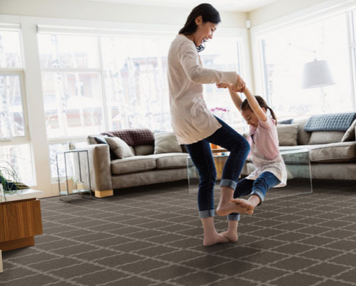 Mother dancing with her daughter on her feet | Carpet Source